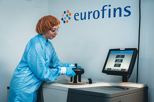 Scientist pulling sample out of instrument.