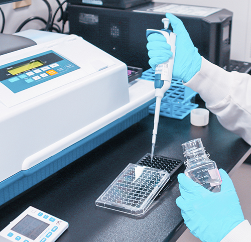 Scientist pipetting sample to prepare for rFC test