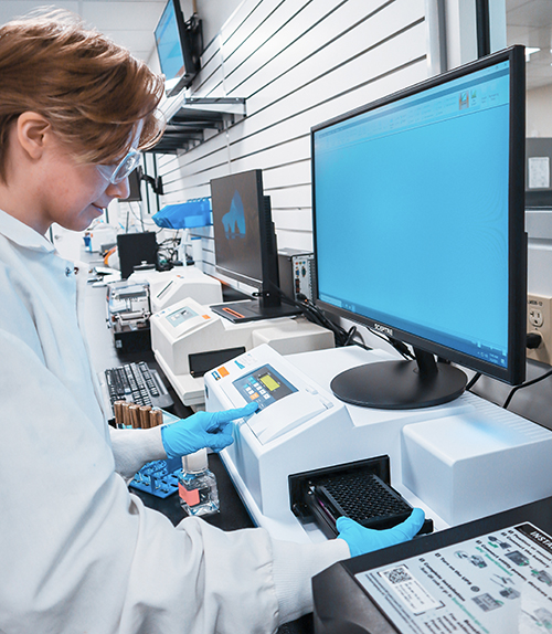 Scientist adding samples to plate reader for analysing