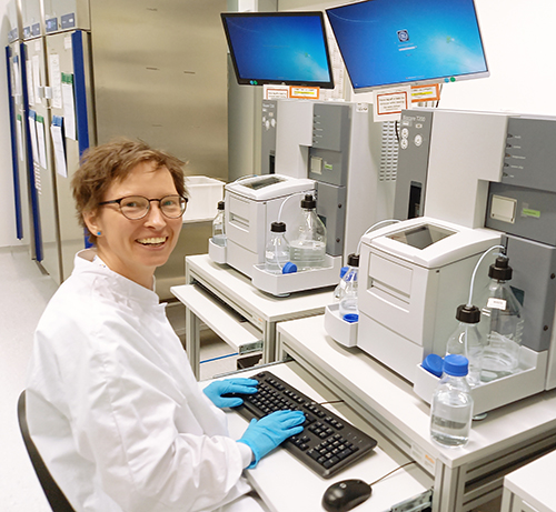 Scientist sitting in front of surface plasmon resonance instrument