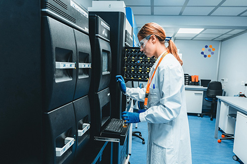 Scientist standing in front of instrument for rapid sterility testing